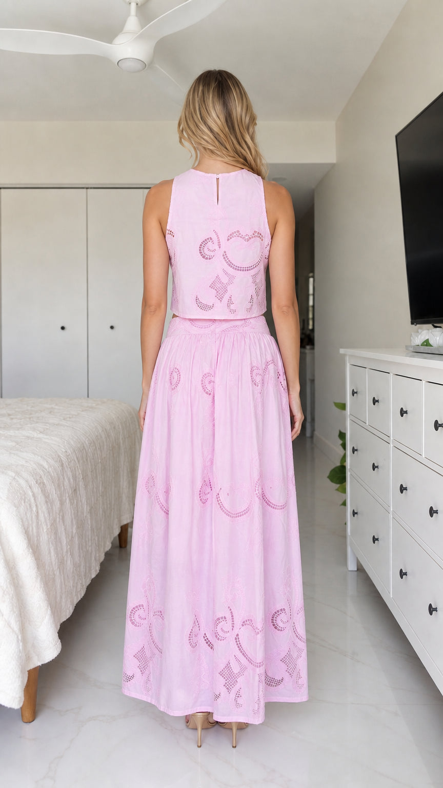 Back view of model in pink embroidered crop top and maxi skirt
