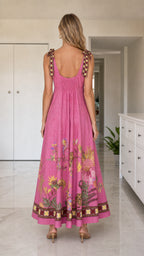 Back view of pink floral maxi dress showing smocked detail