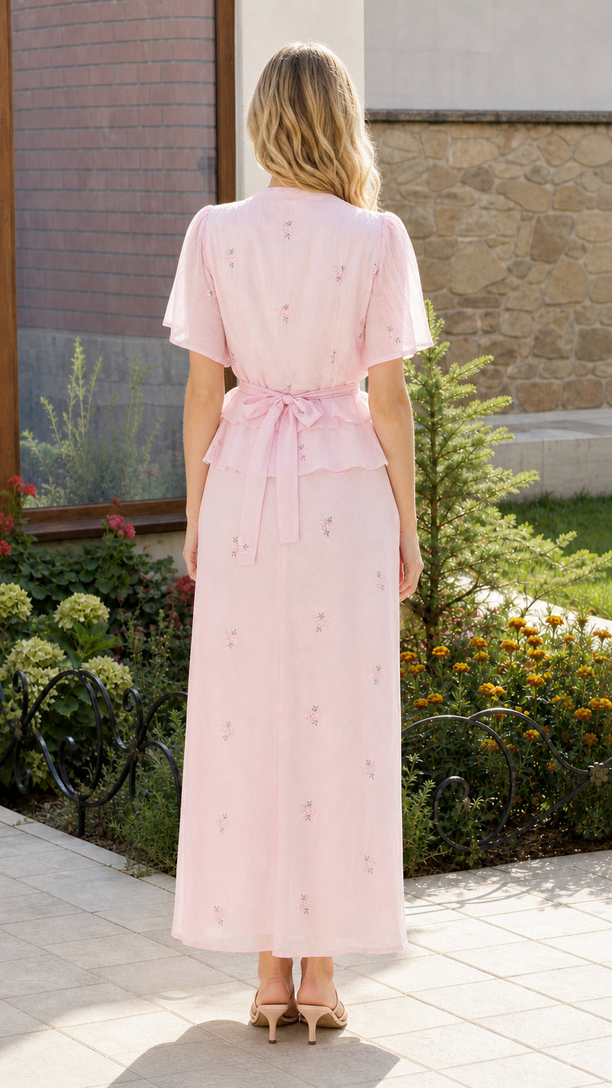 Back view showing tie-back detail on pink top and maxi skirt