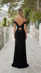 Back view of model showing cutout strap detail on black maxi dress