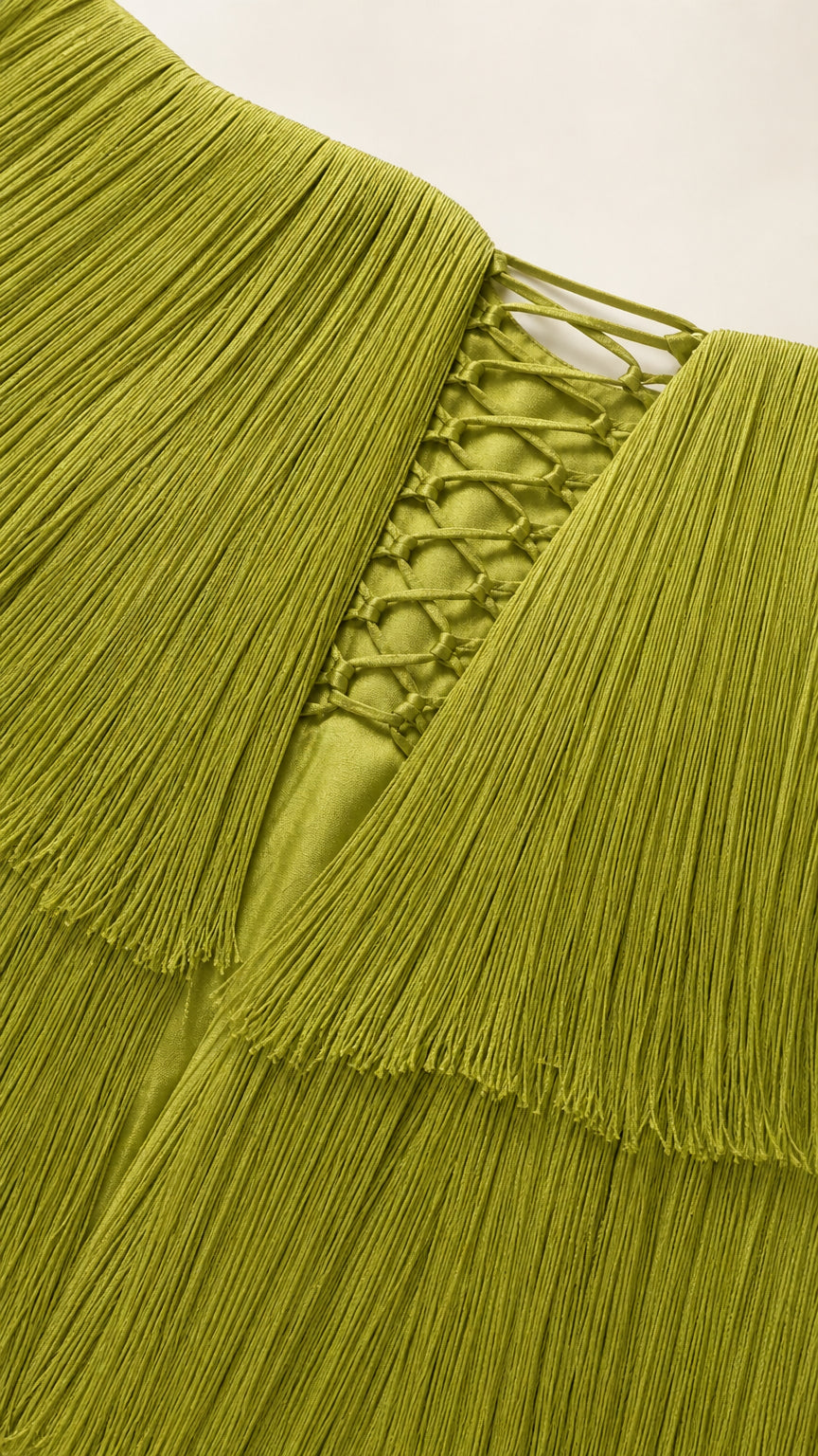 Close-up detail of the texture and lace-up back of the olive green fringe dress