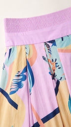 Close-up detail of the pink dress smocked bandeau and abstract pattern