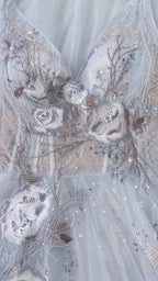 Close-up detail of bodice embroidery and beadwork on light blue gown