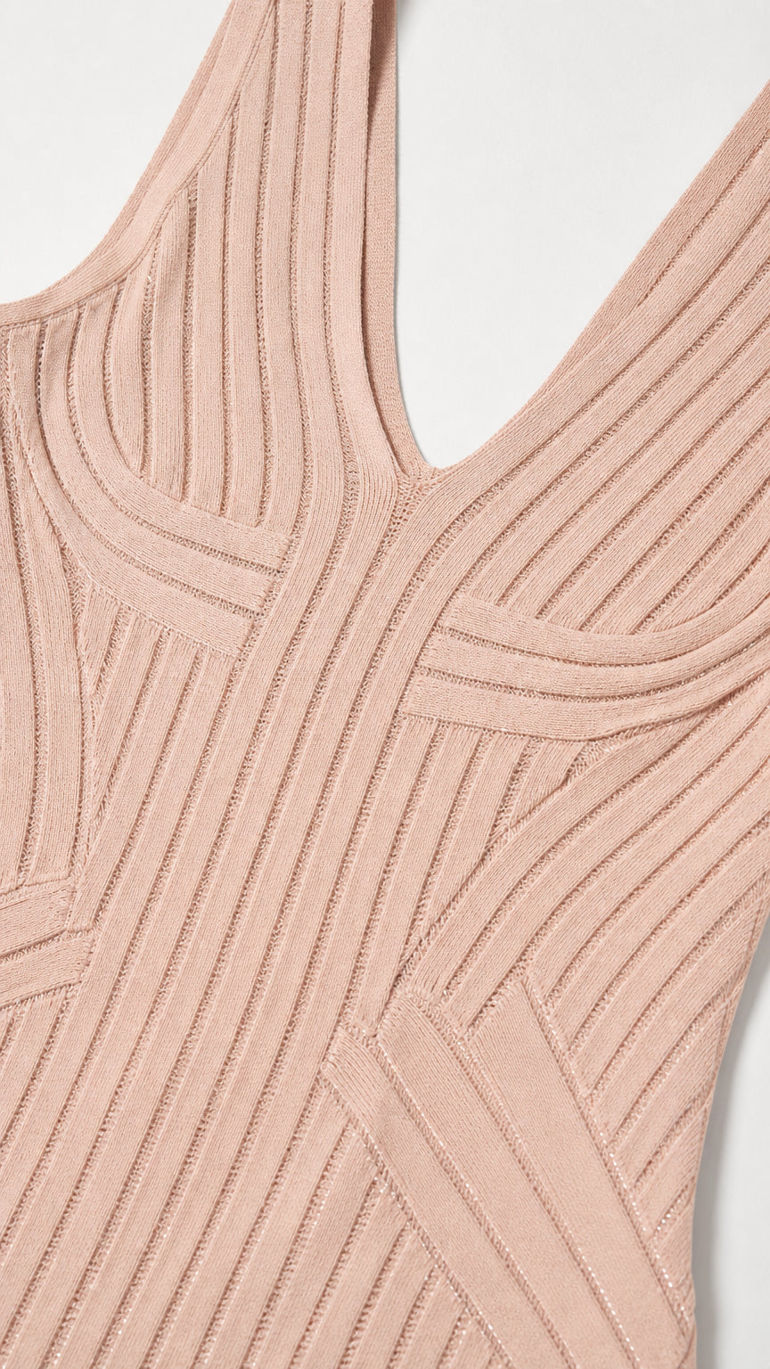 Close-up detail of V-neckline and ribbed knit pattern in blush