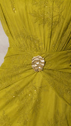 Close-up of gold buckle and embroidery detail