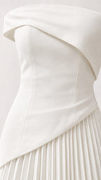 Close-up detail of white structured asymmetric bodice