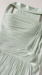 Close-up detail of pleated fabric and strapless neckline