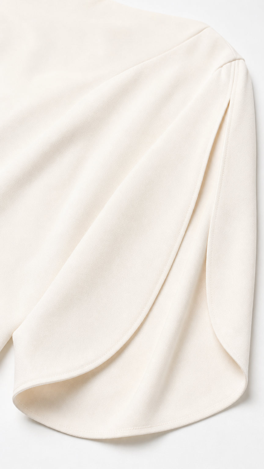 Close-up of smooth ivory fabric and sleeve detail