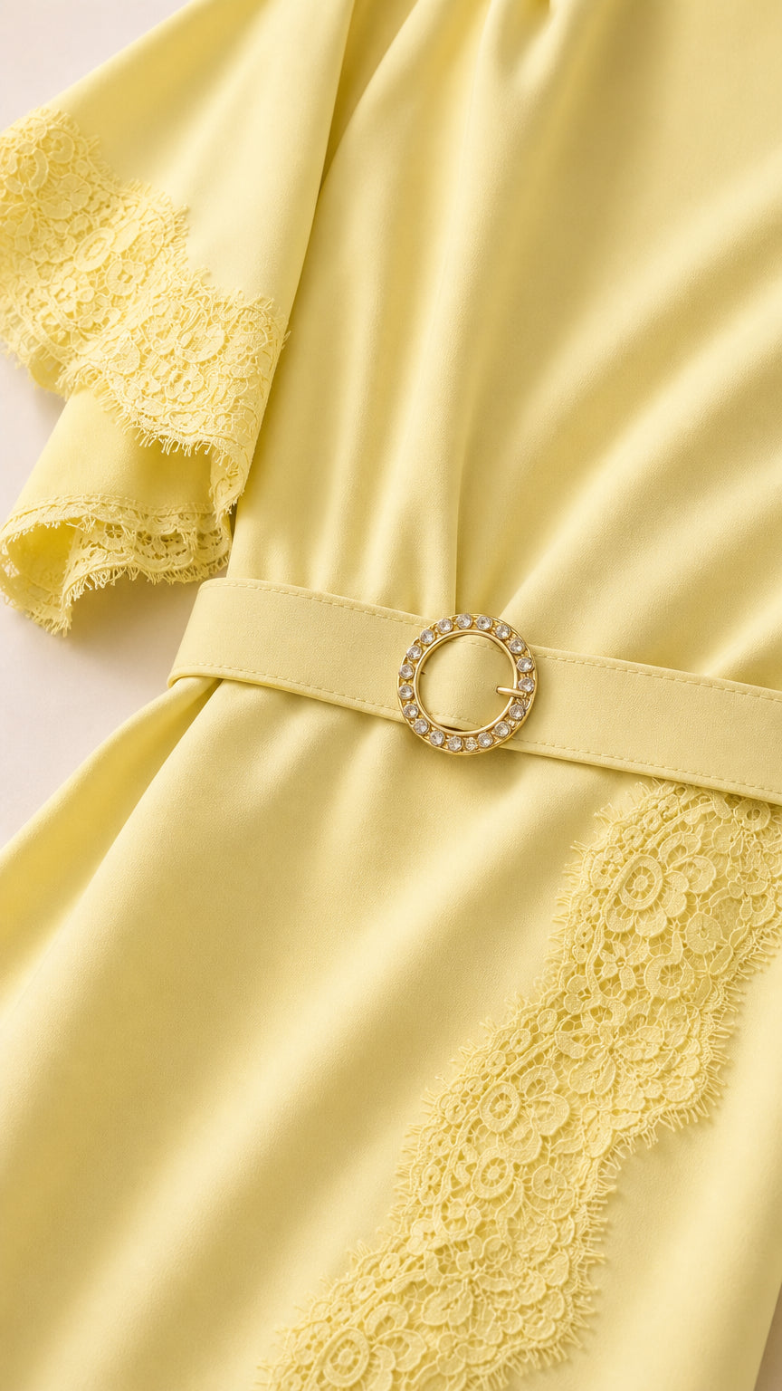 Close-up of flutter sleeve and belt detail on yellow dress