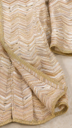 Close-up of metallic chevron knit texture in gold