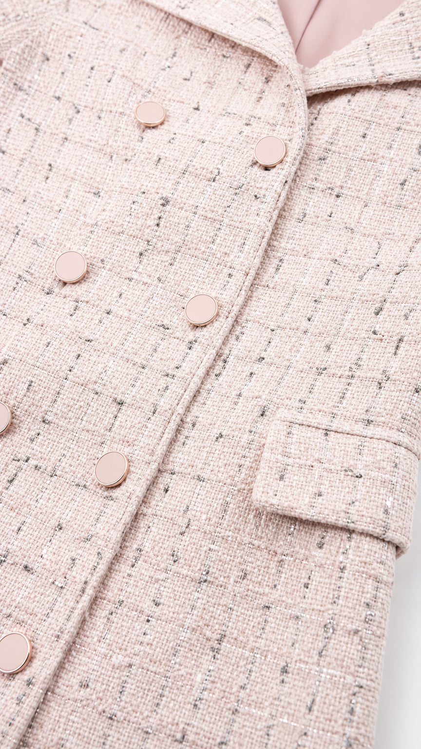 Close-up detail of pink tweed fabric and buttons