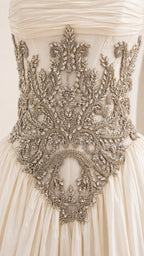Close-up detail of ornate metallic waist embroidery