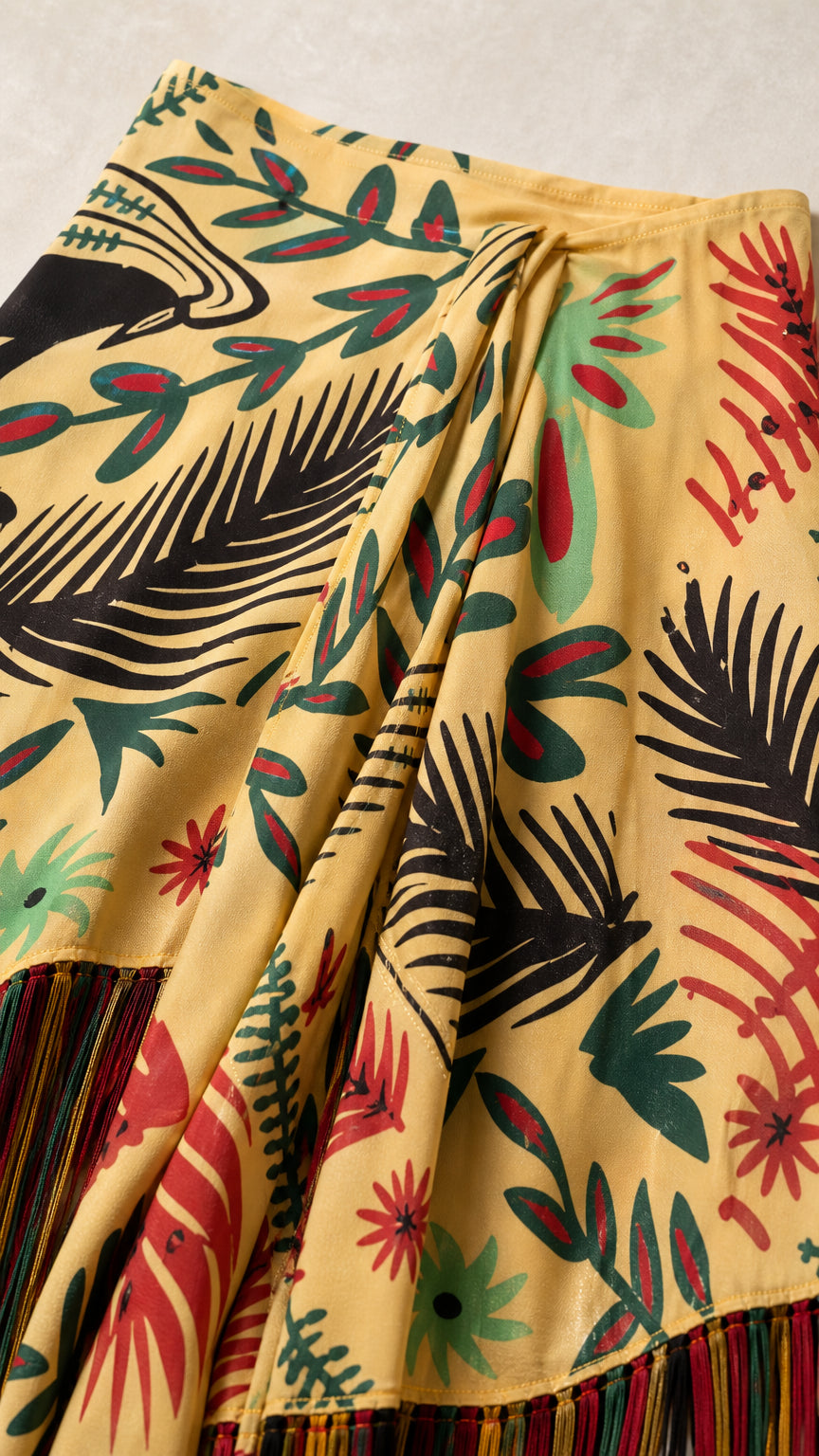 Close up of yellow tropical print fabric and fringe hem