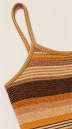 Close-up detail of strap and knit texture on camel dress