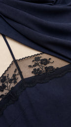 Close-up detail of sheer lace neckline and smooth fabric texture