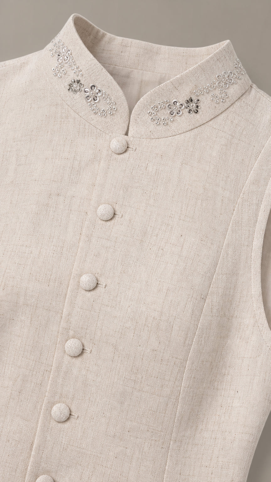 Close-up detail of rhinestone embellished stand collar and buttons