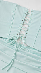 Close-up detail of lace-up corset back and smooth fabric