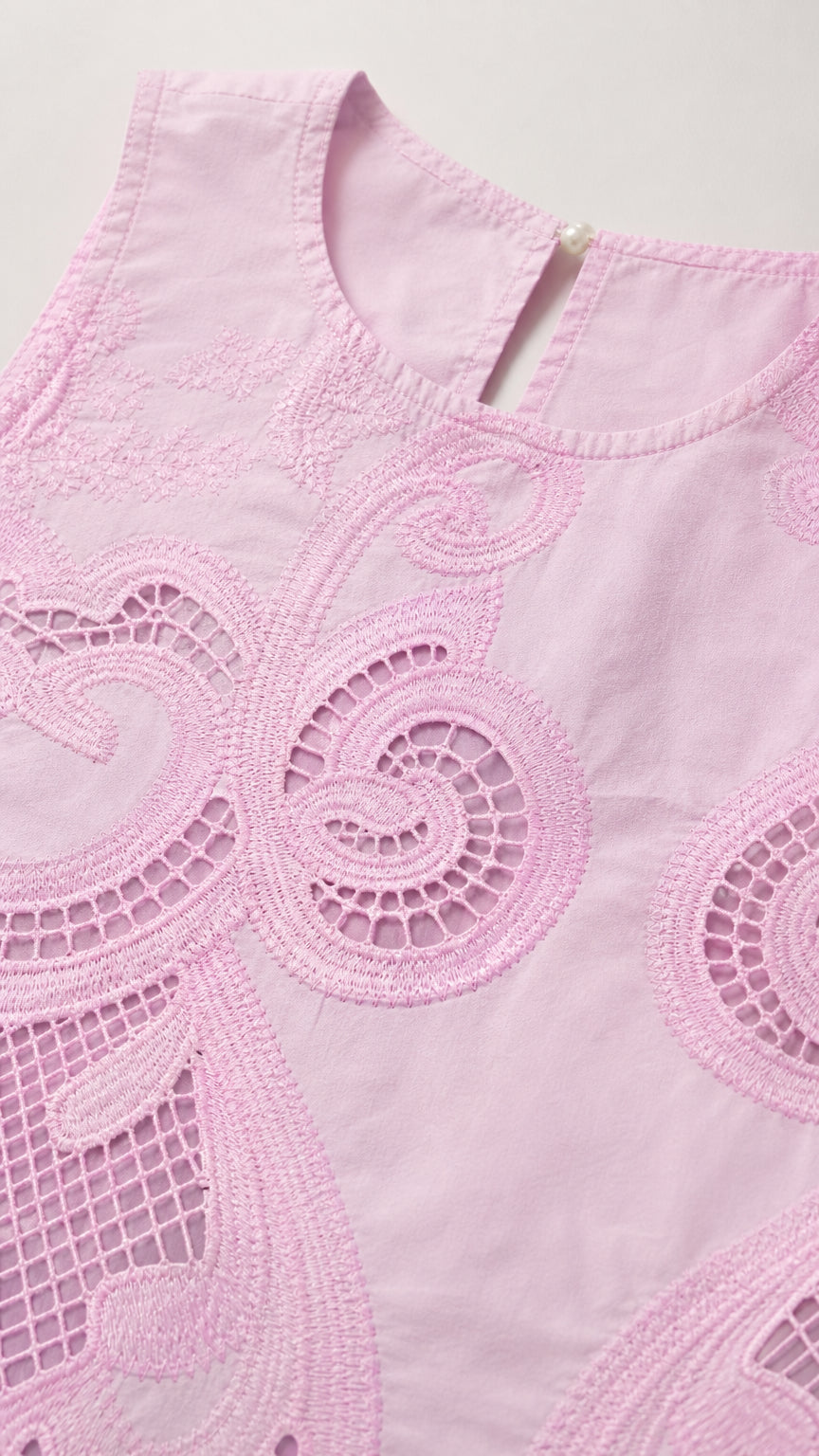 Close-up detail of the pink crop top neckline and embroidery pattern