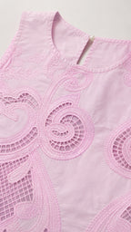 Close-up detail of the pink crop top neckline and embroidery pattern