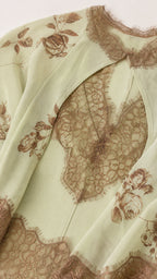 Close up of lace trim and floral print detail on mint green dress
