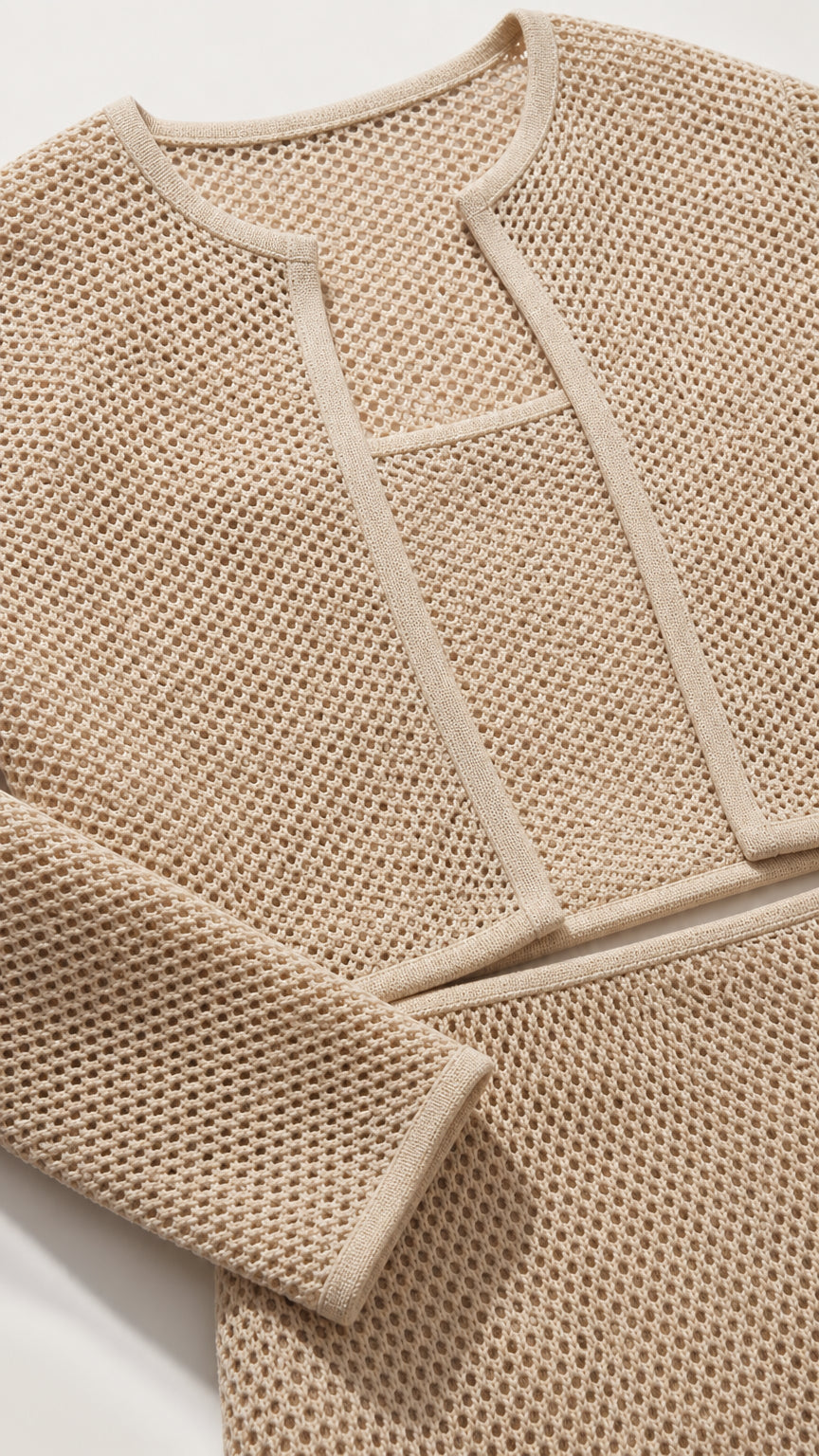 Close-up detail of beige textured knit fabric and jacket trim