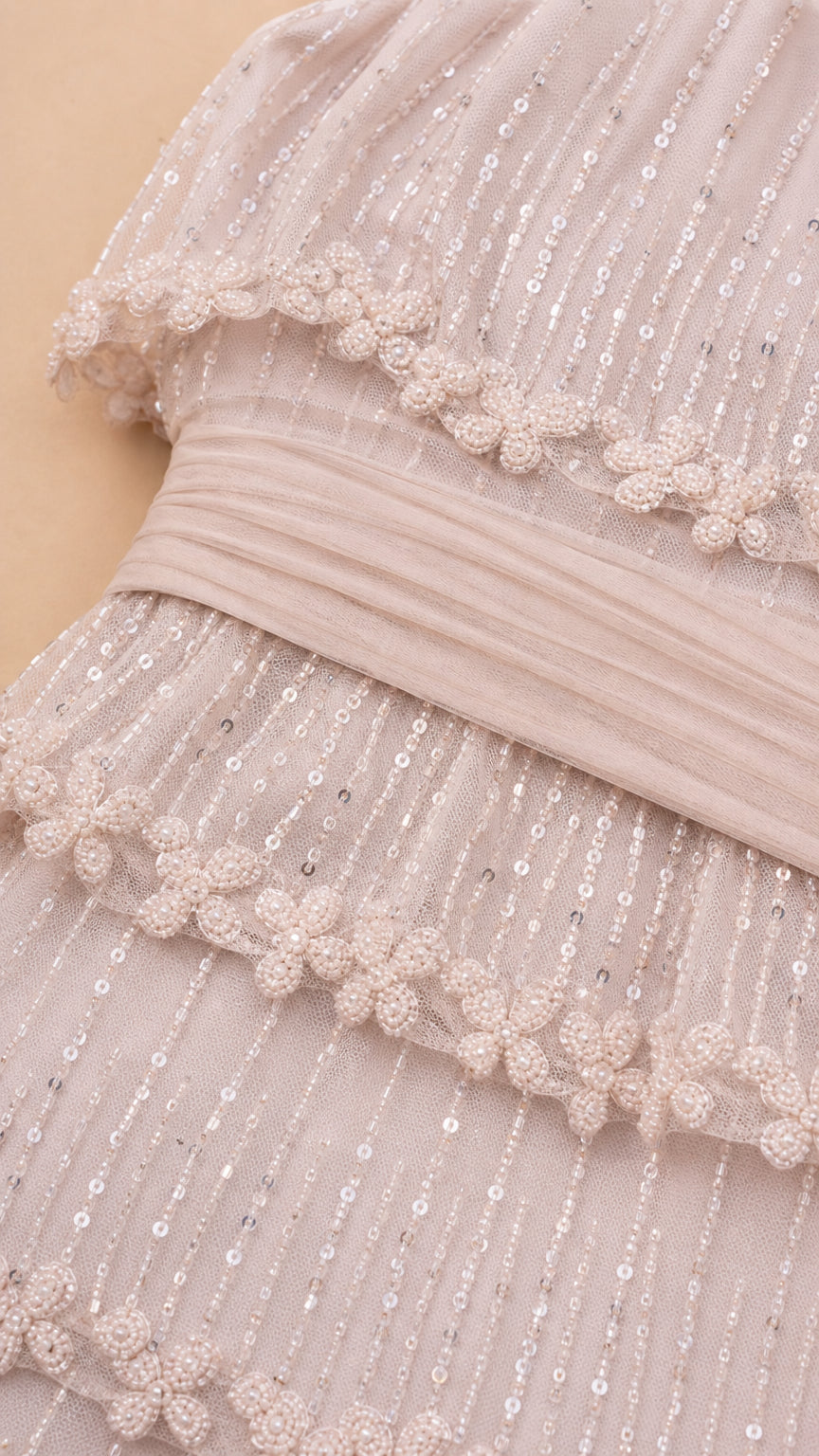 Close-up detail of tiered beading and sequin embellishments
