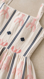 Close-up detail of lobster and seashell embroidery on fabric