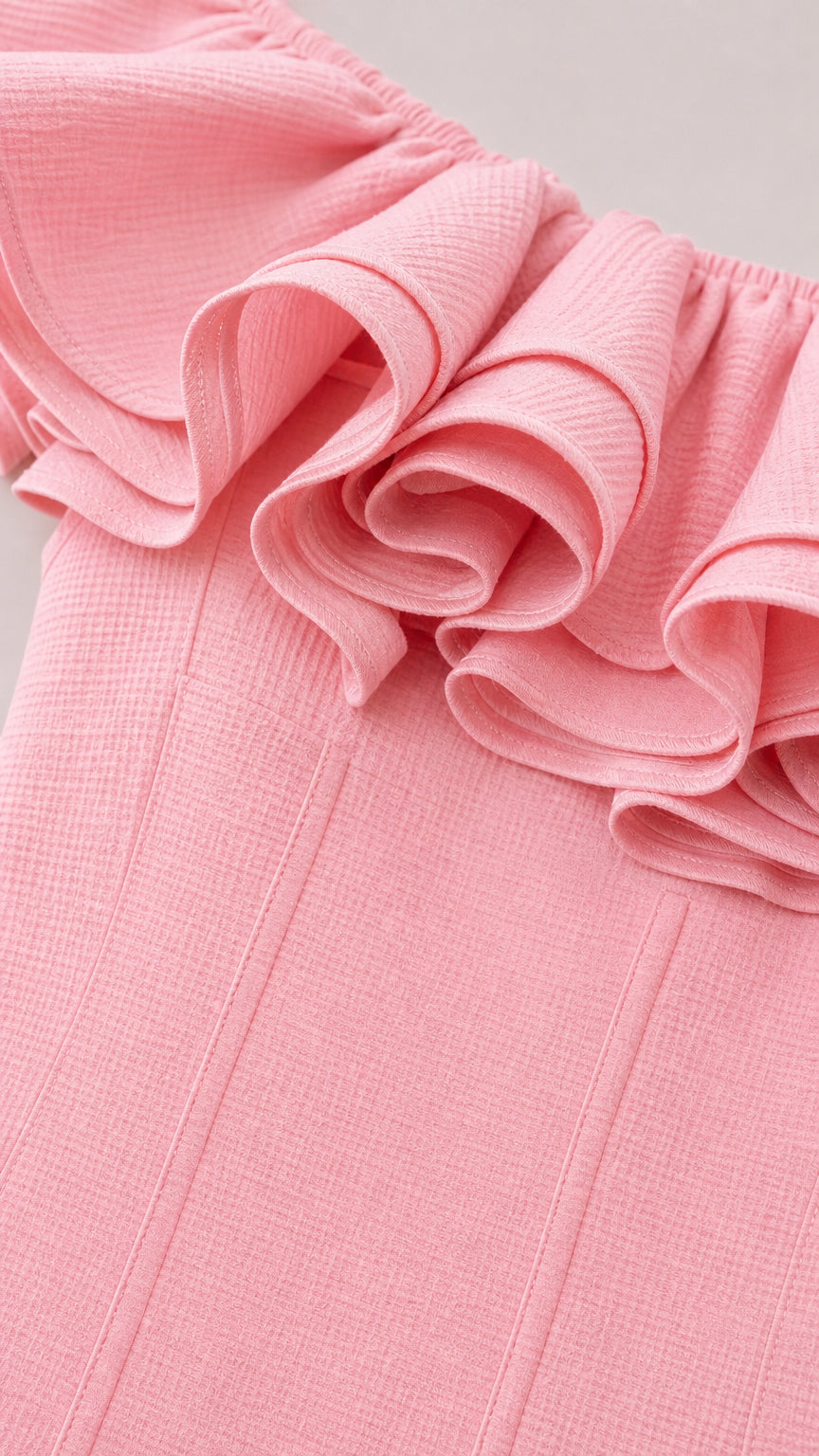 Close-up detail of structured ruffle neckline and fabric texture