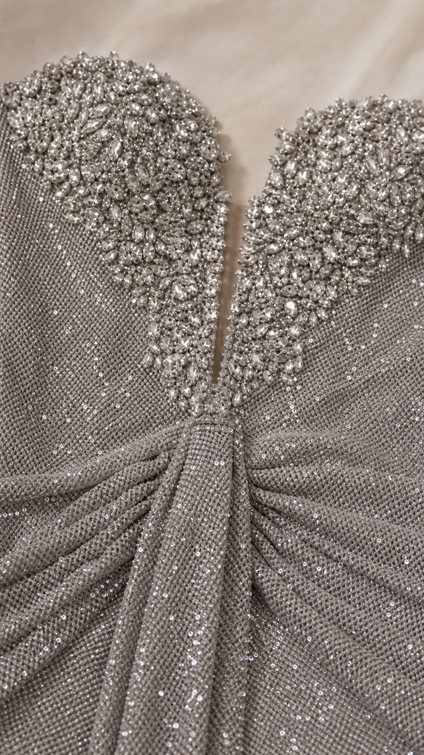 Close-up detail of embellished sweetheart neckline and textured fabric