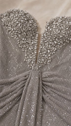 Close-up detail of embellished sweetheart neckline and textured fabric
