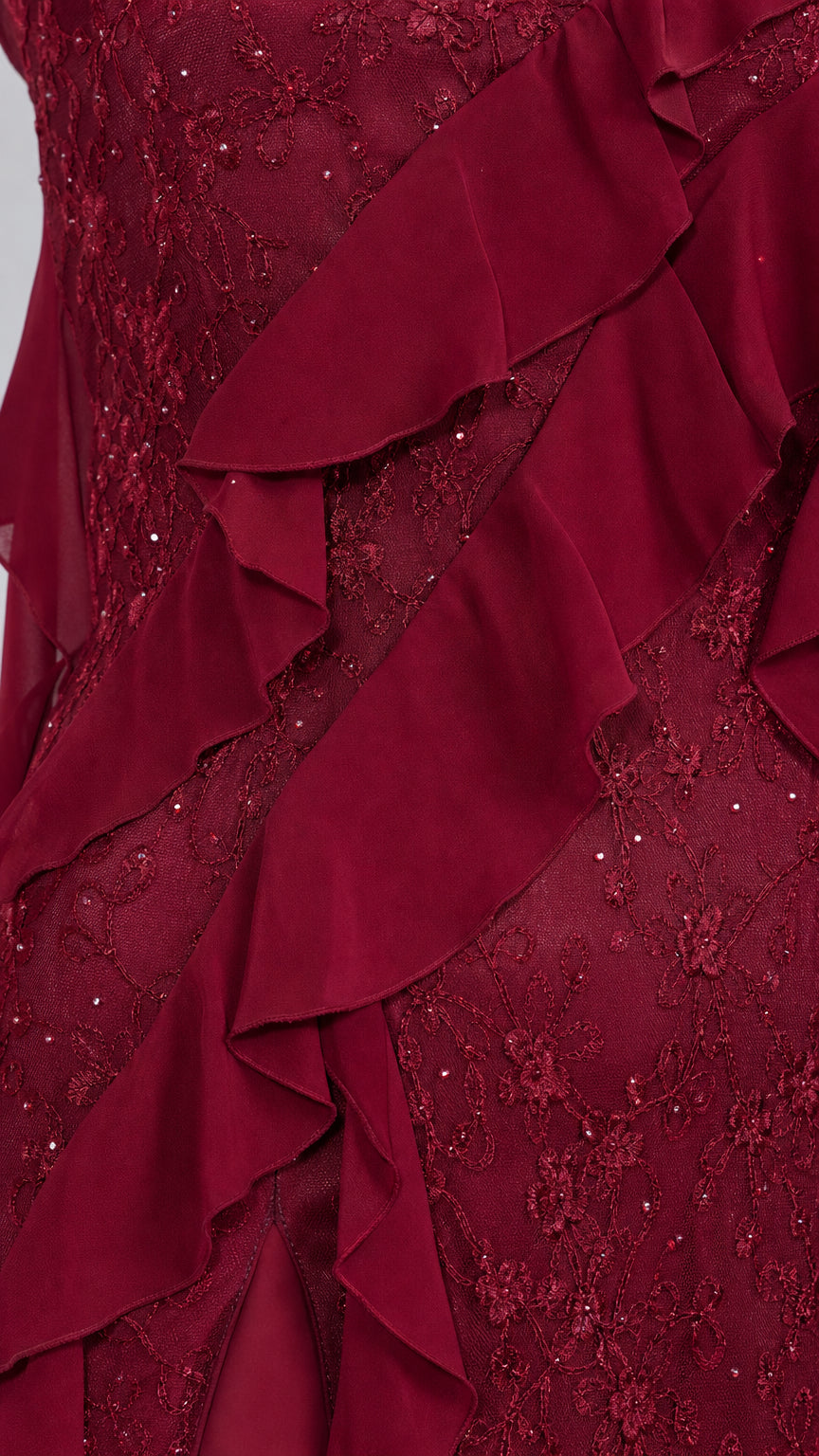Close-up detail of burgundy lace fabric and cascading ruffles