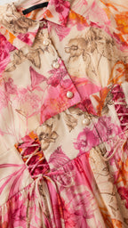 Close-up detail of shirt collar, pearl buttons, and lace-up waist on floral dress