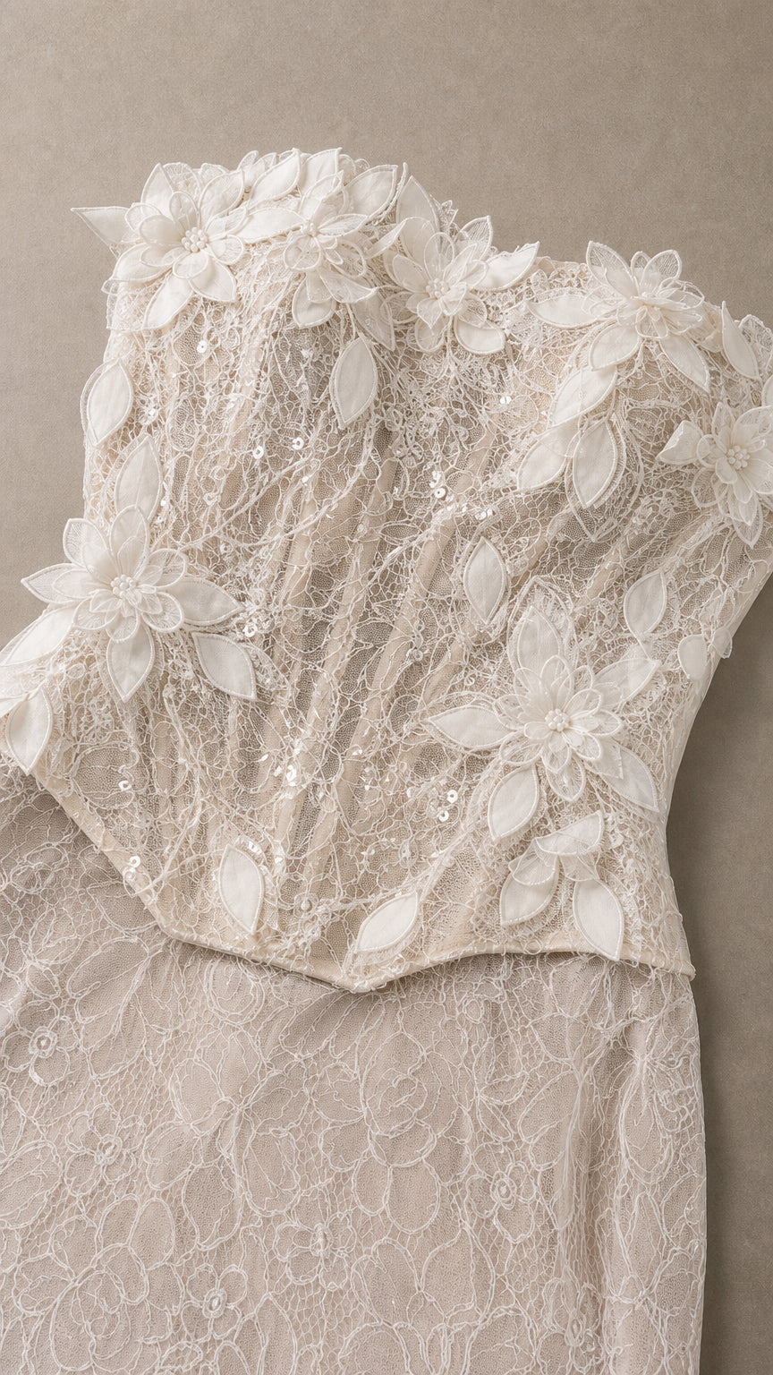 Close-up detail of 3D floral appliques and textured lace on bodice