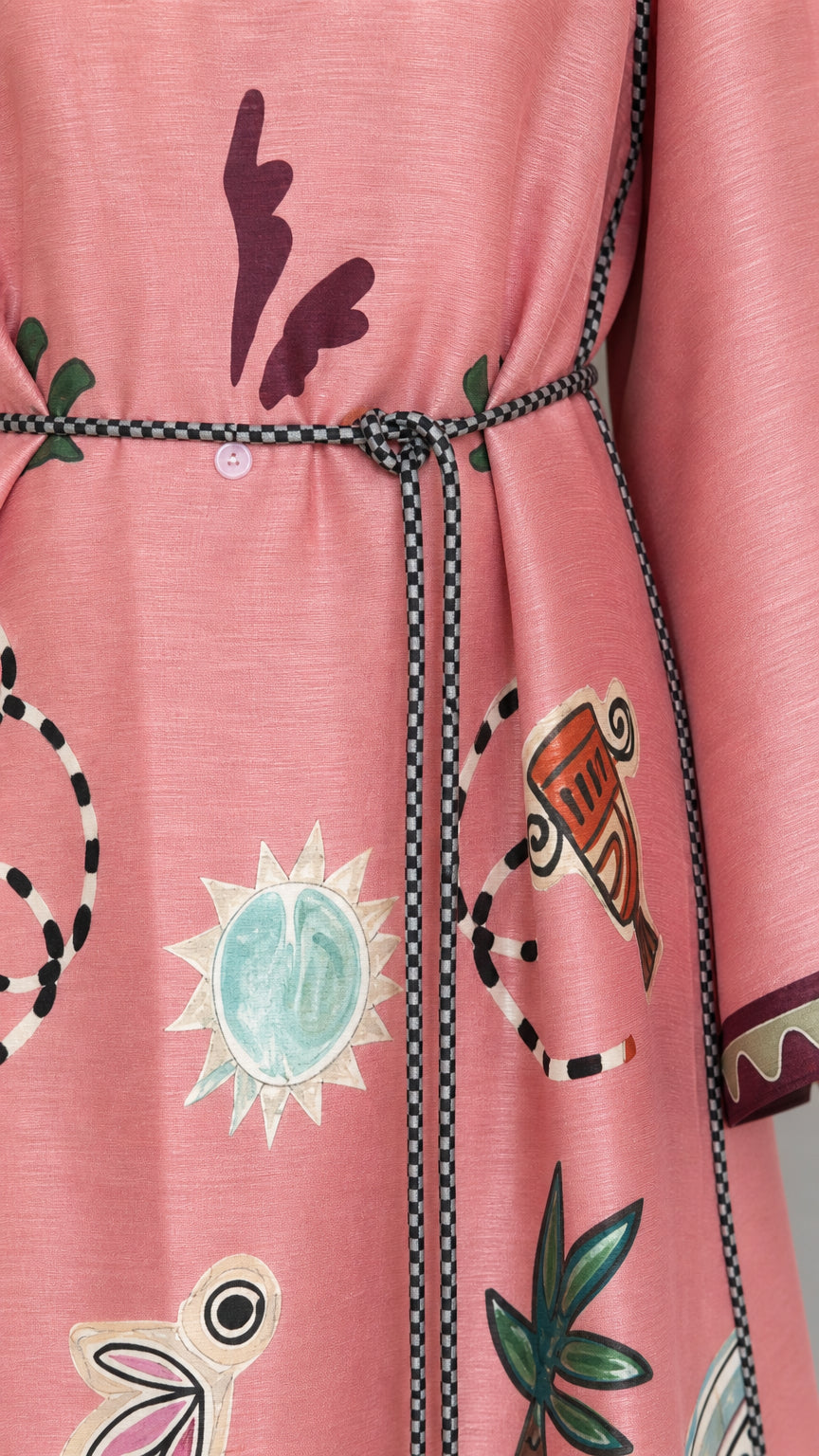 Close-up detail of pink dress print and belt