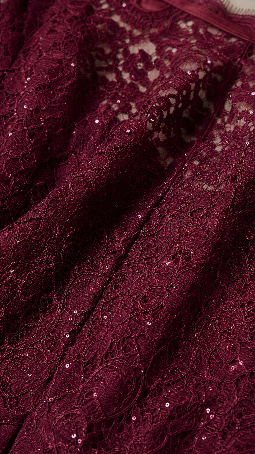 Close-up detail of burgundy sequin lace fabric